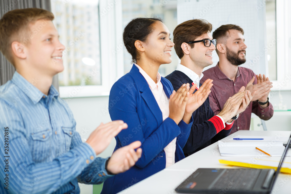 Group of creative businesspeople applauding work presentation Group of creative businesspeople applauding work presentation