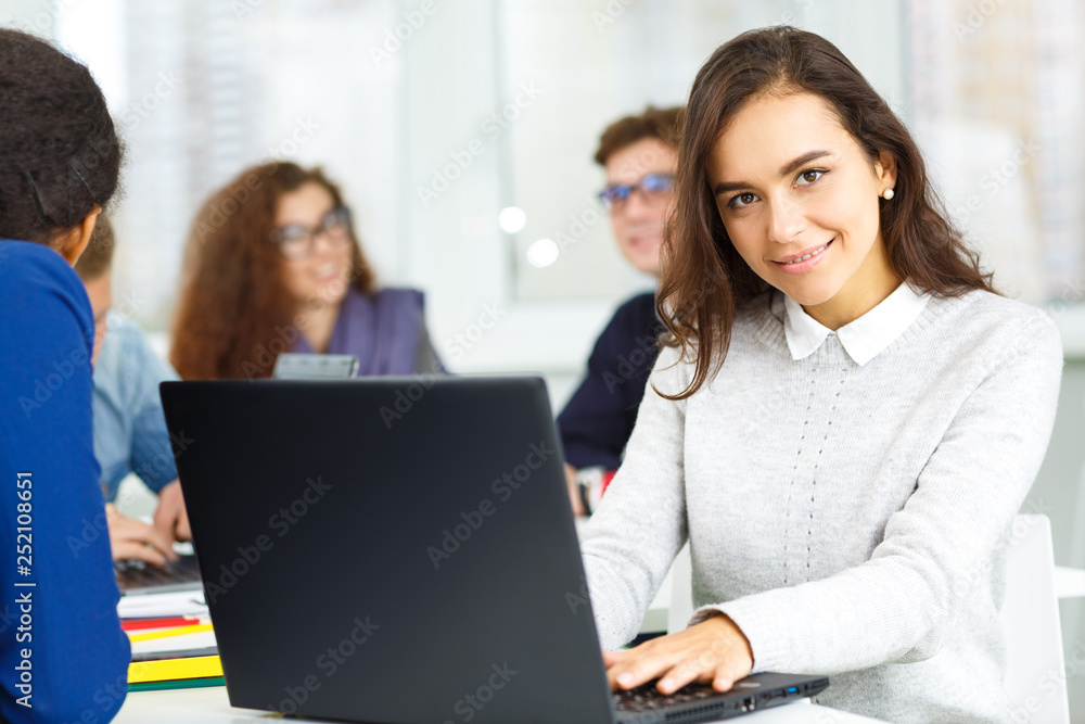 Beautiful young woman working on her computer at the office of her startup creative team Beautiful young woman working on her computer at the office of her startup creative team