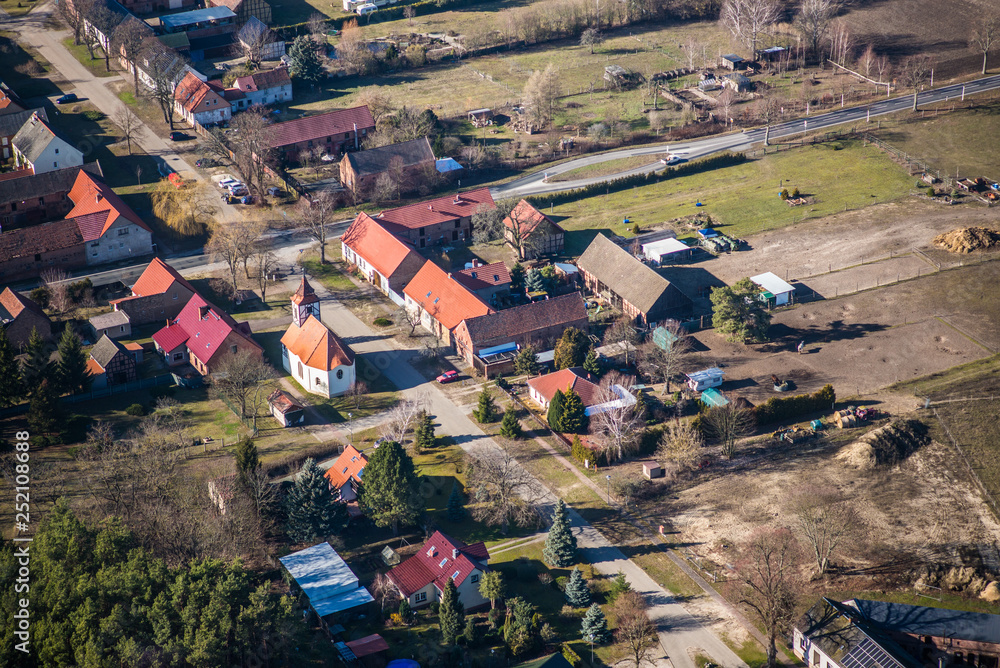 small village Klausdorf (belongs to Treuenbrietzen) with a little cute church in the centre - state of Brandenburg, Germany - aerial view 
