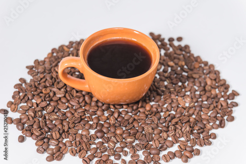 coffee beans and a cup of coffee on a white background