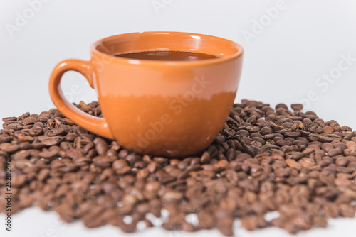 coffee beans and a cup of coffee on a white background