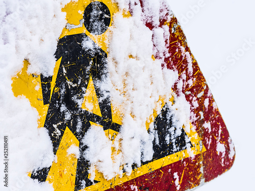 Road works sign covered with snow