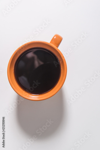 orange cup of coffee on a white background