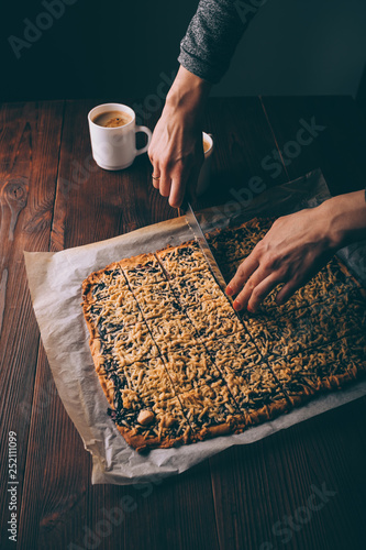 View from above woman's hands cutting freshly baked viennese cookies