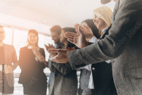 Multiracial group of business people clapping hands to congratulate their boss - Business company team, standing ovation after a successful meeting photo