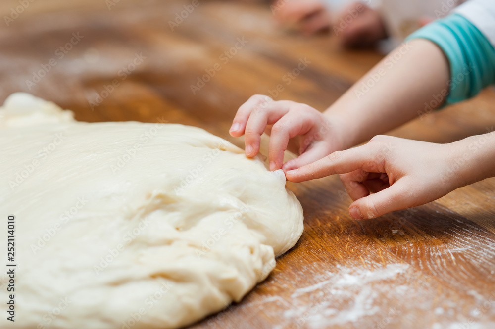 Small children take the dough. Hands close up Small children take the dough. Hands close up