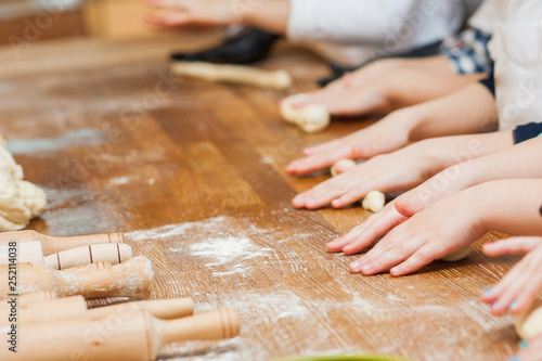 Children make a product from flour, hands close up
