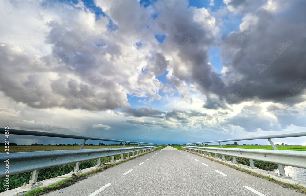 Fototapeta premium a motor way, horizon and blue sky with clouds