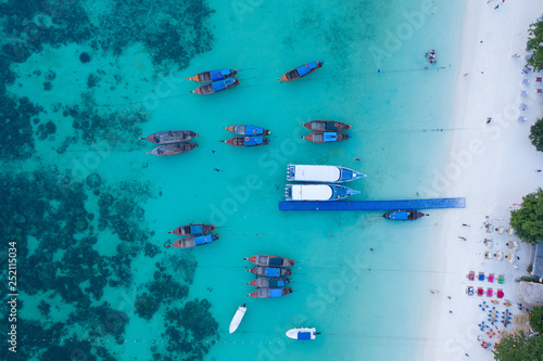 Longtail boats from the air, paradise island , crystal clear water, amazing scenery, on fyre.  © remy