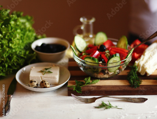 greek salad with ingredients on the table