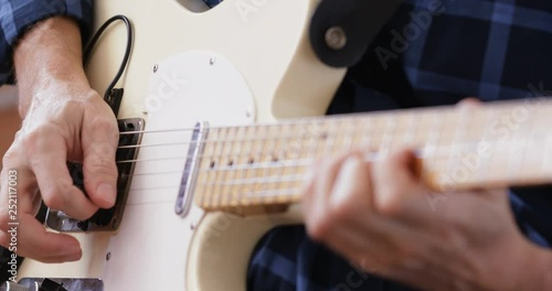 Man practicing electric guitar, close-up