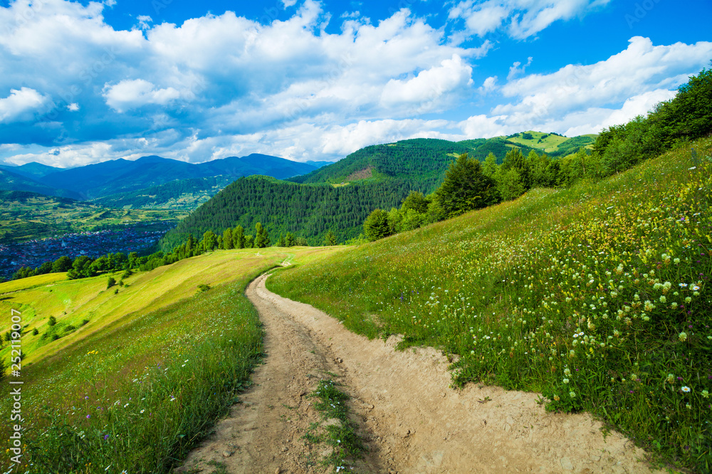 Beautiful winding road in spring rolling through the hills