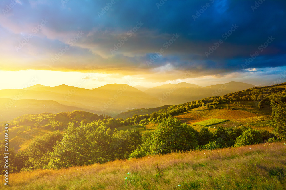 Last rays of golden sunlight over the hills in Romania