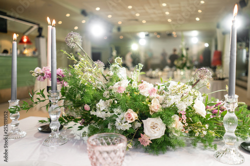 Floral decoration for wedding ceremony romance dining. Wedding banquet , festive decor. Bouquet from spring and summer flowers. Table layout. Restaurant interior. Concept of service and catering.