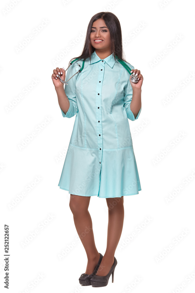 Adorable indian female doctor nurse with stethoscope in aquamarine dress isolated on white background Adorable indian female doctor nurse with stethoscope in aquamarine dress isolated on white background