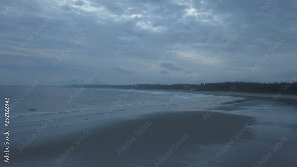 Aerial seascape view of the Pacific Ocean Coast during a cloudy summer sunset. Taken near Tofino and Ucluelet, Vancouver Island, BC, Canada. Aerial seascape view of the Pacific Ocean Coast during a cloudy summer sunset. Taken near Tofino and Ucluelet, Vancouver Island, BC, Canada.