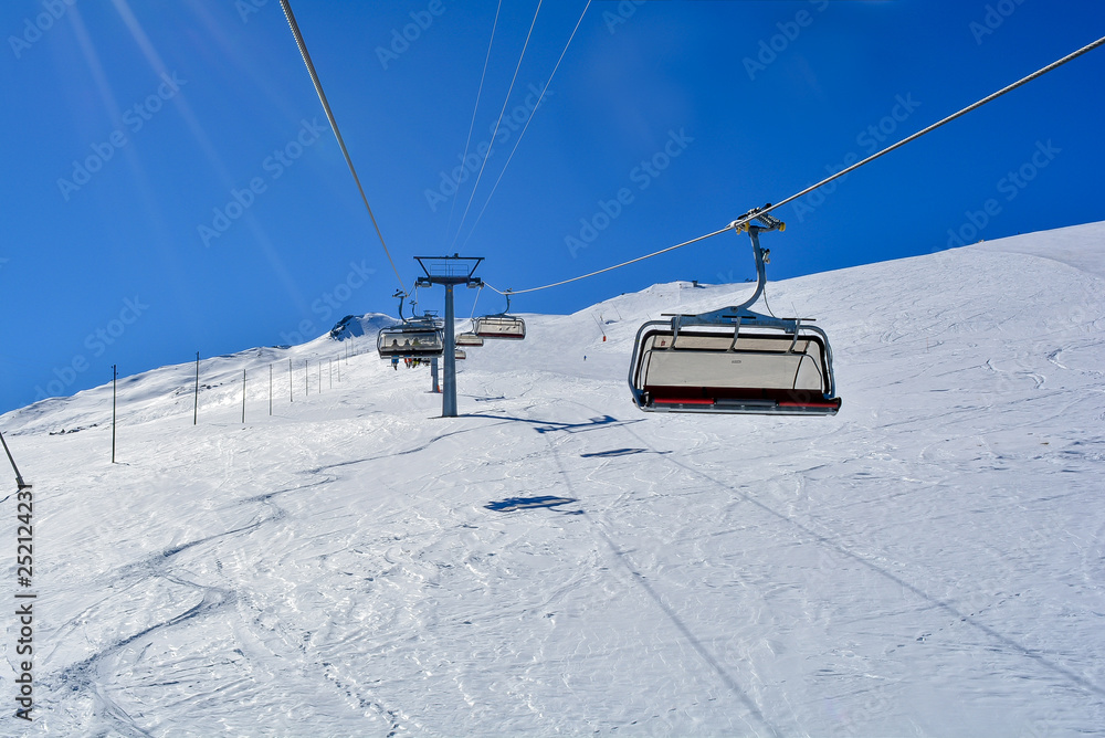 A Chair Lift in the Alps with sunshine A Chair Lift in the Alps with sunshine