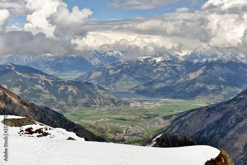 Beautiful panoramic view of the famous city of Zell am See with idyllic Zeller Lake and blooming meadows on a sunny spring day in Salzburg, Salzburger Land, Austria photo