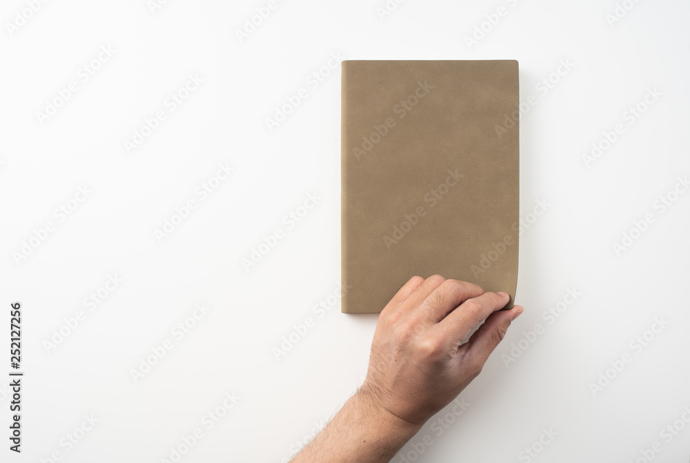 man hand hold brown notebook on white background man hand hold brown notebook on white background