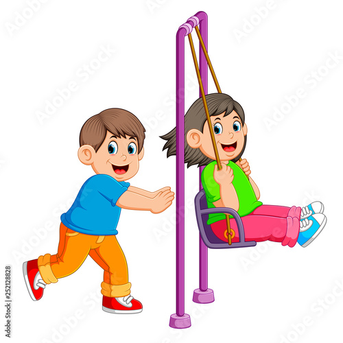 brother pushing sister on swing