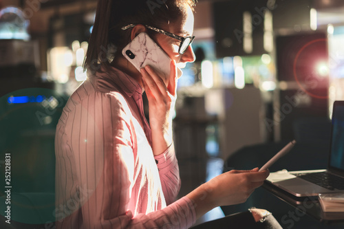 Woman working long hours, sitting in a coffee shop photo