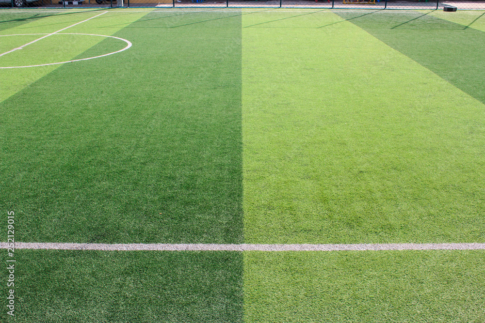 Fototapeta premium The white Line marking on the artificial green grass soccer field