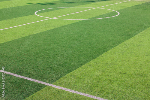 Fototapeta Naklejka Na Ścianę i Meble -  The white Line marking on the artificial green grass soccer field