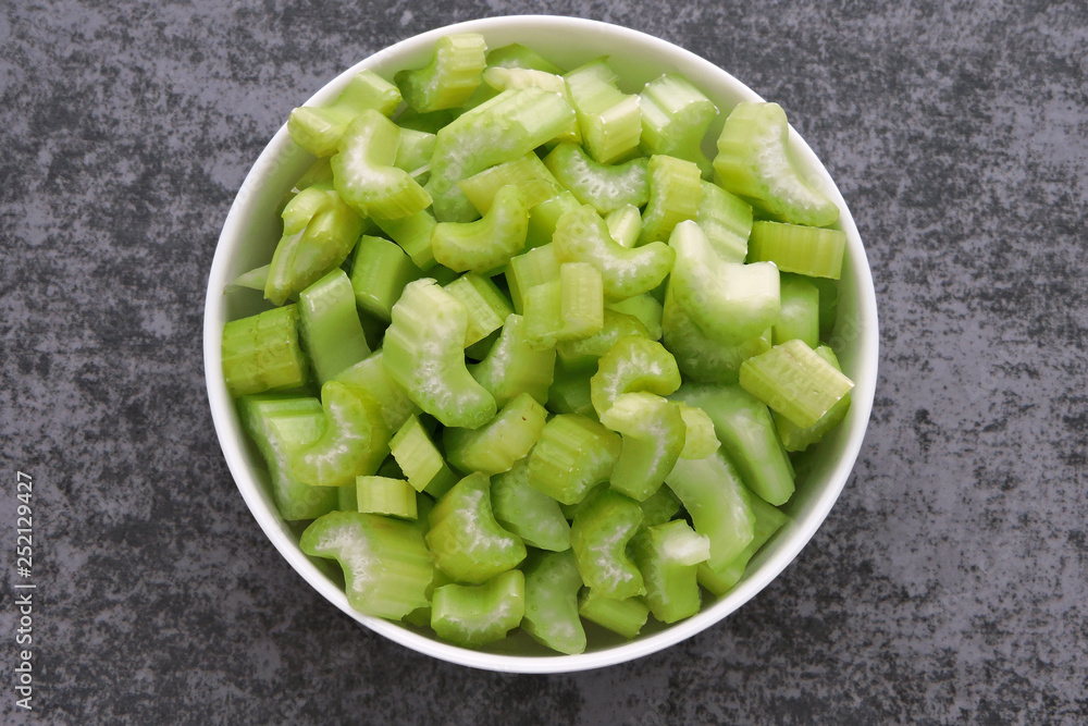 Chopped celery stalks in a bowl. Product for diet and proper nutrition. Chopped celery stalks in a bowl. Product for diet and proper nutrition.