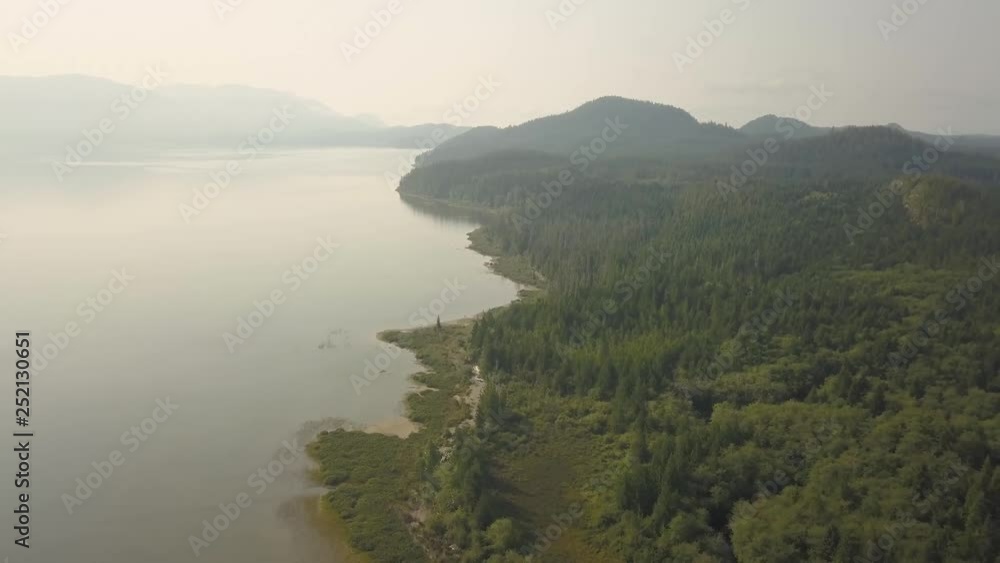 Aerial panoramic landscape view of Kennedy Lake during a cloudy summer day. Taken near Tofino and Ucluelet, Vancouver Island, BC, Canada. Aerial panoramic landscape view of Kennedy Lake during a cloudy summer day. Taken near Tofino and Ucluelet, Vancouver Island, BC, Canada.