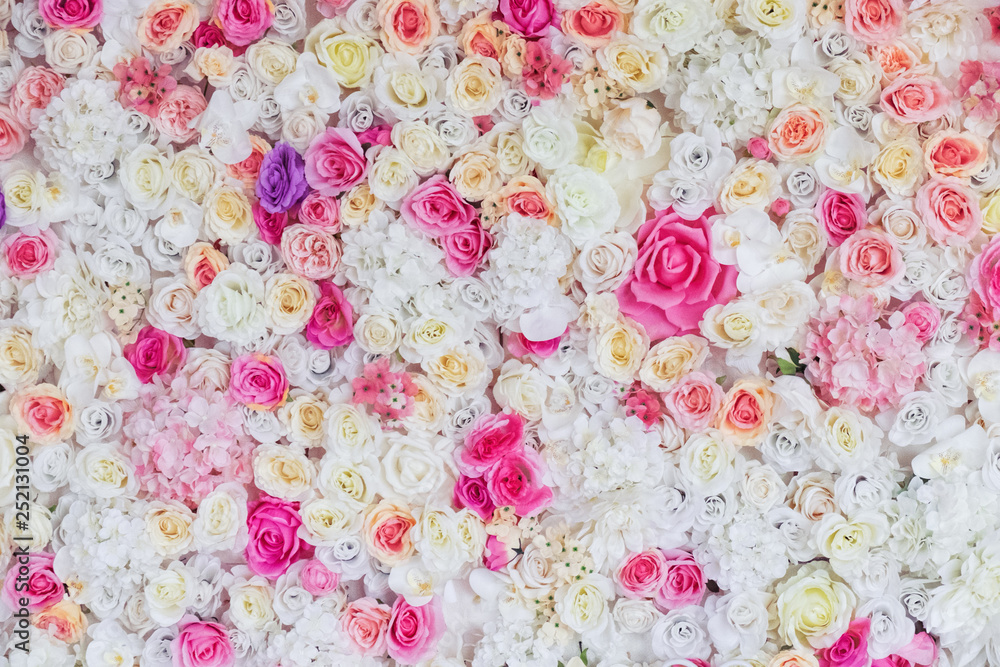Fototapeta Flower texture background for wedding scene. White, lilac, pink, red roses and peonies. Artificial flowers on the wall. Banner for website.