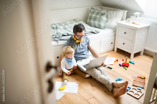 Father with his little son working from home