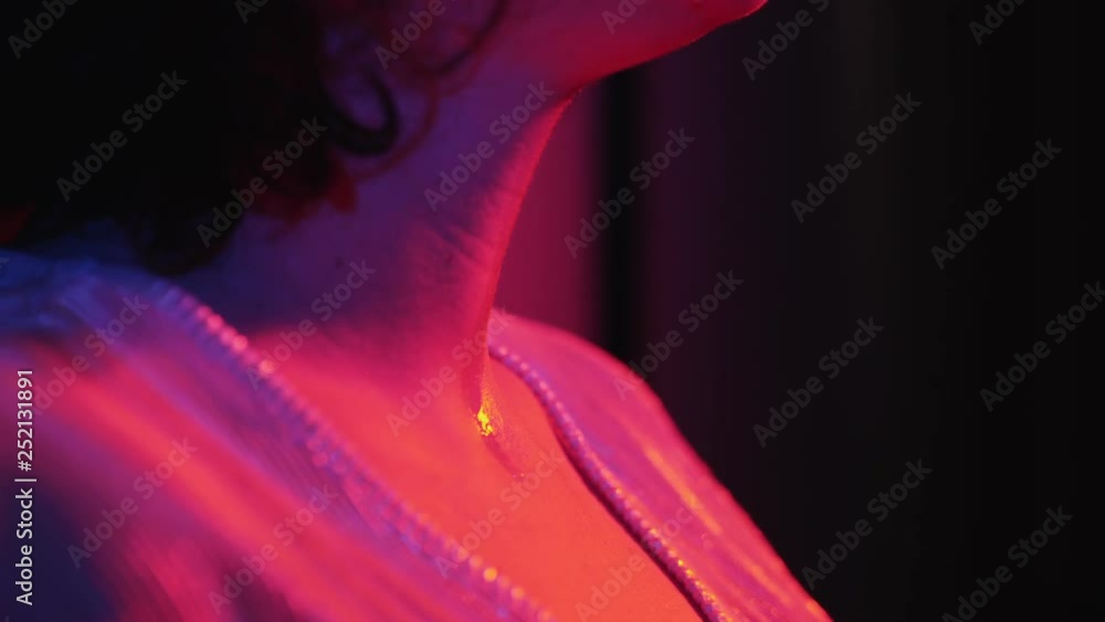 Scared sad lonely woman in the dark crying,tears dripping on the chest- profile Scared sad lonely woman in the dark crying,tears dripping on the chest- profile