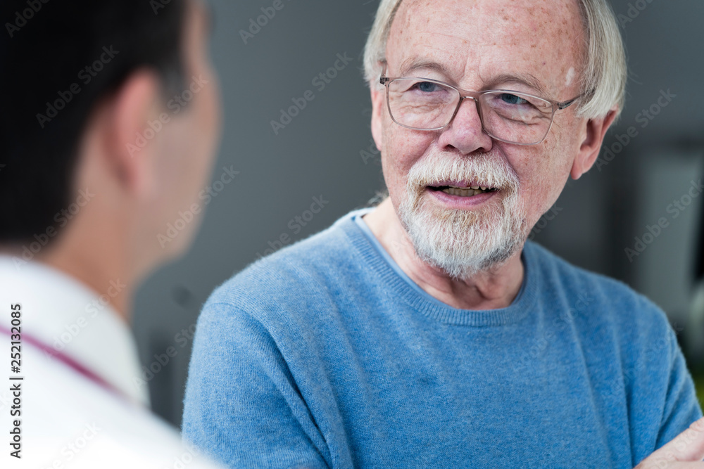 Senior patient talking to doctor in medical practice Senior patient talking to doctor in medical practice