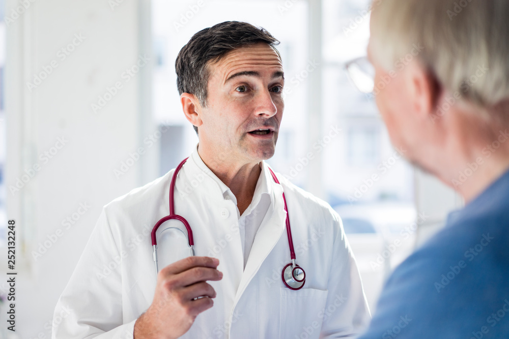 Portrait of doctor and talking to patient in medical practice Portrait of doctor and talking to patient in medical practice