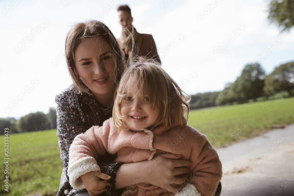 Portrait of happy blond little girl in her mothers arms Portrait of happy blond little girl in her mothers arms