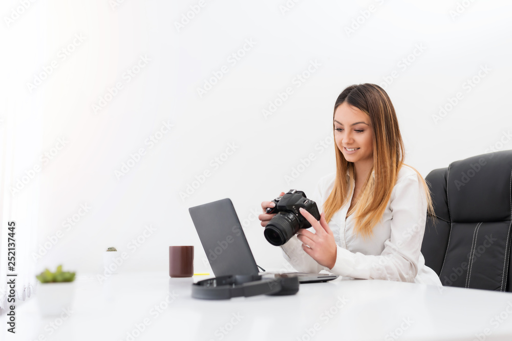 Young beautiful woman photographer, checking photos she took outside. Young beautiful woman photographer, checking photos she took outside.