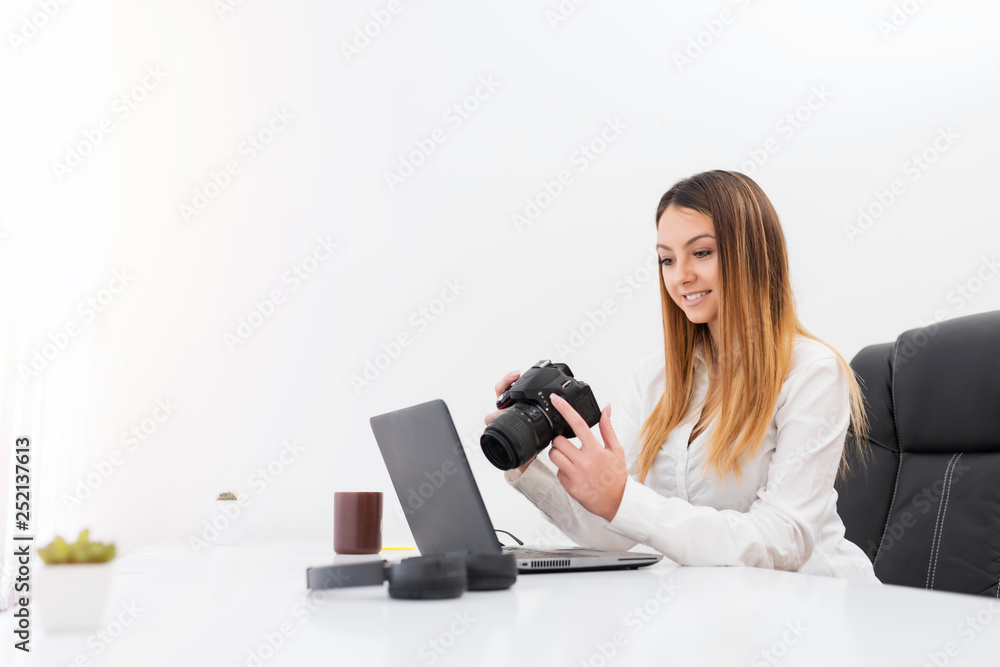 Cheerful freelance photographer woman, at home office editing photos. Cheerful freelance photographer woman, at home office editing photos.