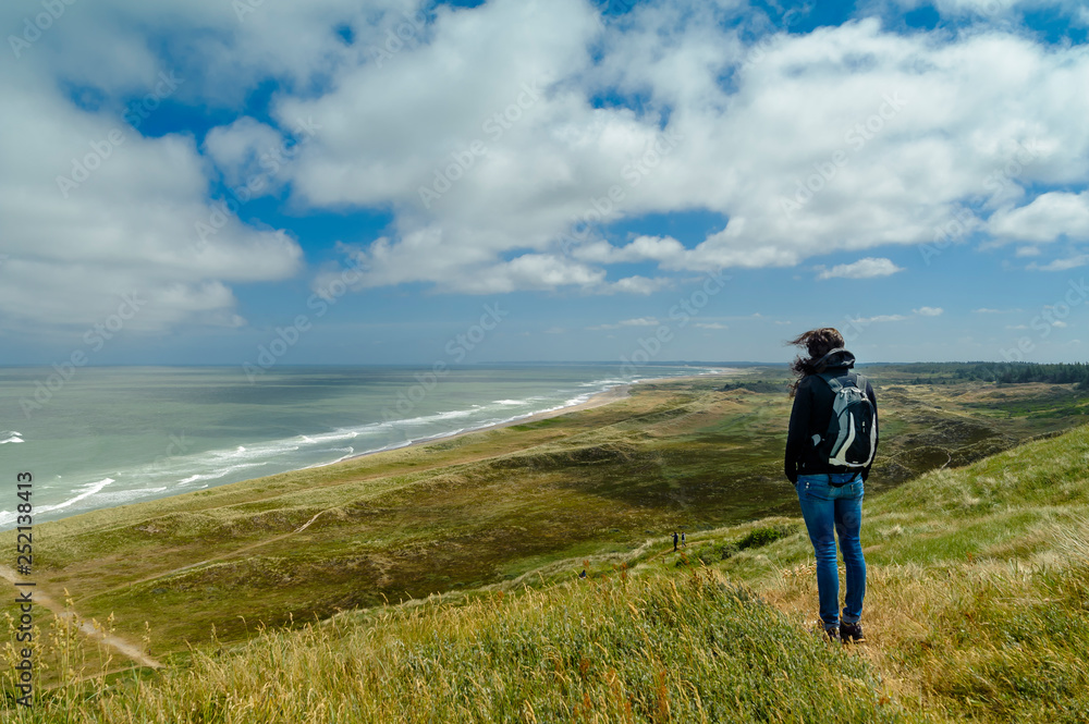 Denmark, Jutland, woman standing in dune landscape Denmark, Jutland, woman standing in dune landscape
