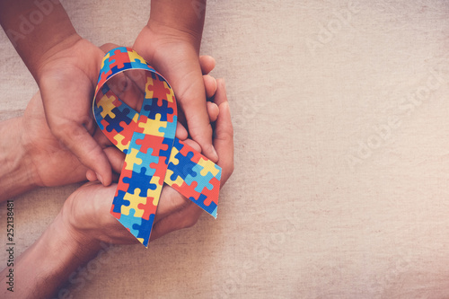Hands holding puzzle ribbon, World Autism Awareness Day, Autism spectrum  disorder photo