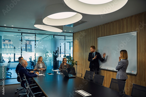 Businessman leading a presentation during a  meeting photo