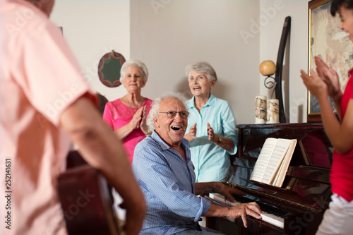 Elderly people making music in retirement home photo