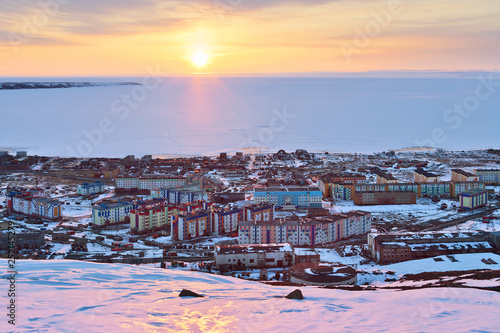 Pevek is the northernmost city in Russia. In May, during a polar day in the Arctic, the sun does not disappear over the horizon at night. The Arctic Ocean is covered in ice. Chukotka, Russian Far East photo