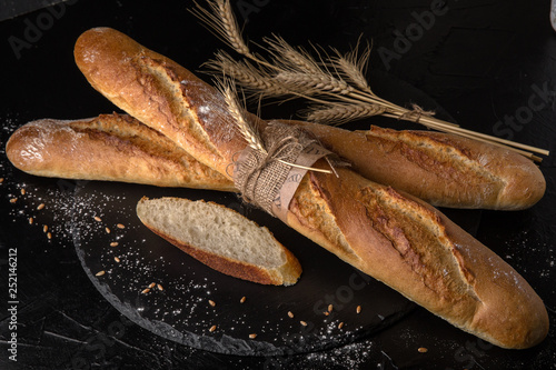 Freshly baked delicious baguette bread Homebaked. Useful, tasty, nutritious. photo