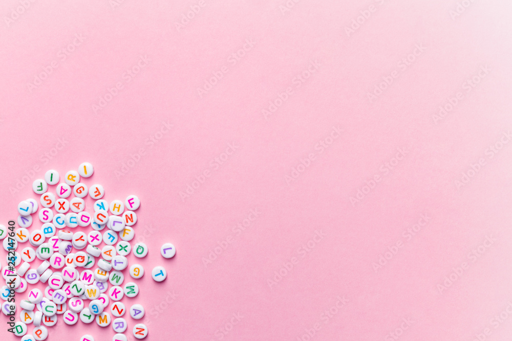creative minimalist background, alphabet letter beads on pink, education concept creative minimalist background, alphabet letter beads on pink, education concept