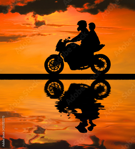 silhouette of lover couple in sunset with classic motorcycle