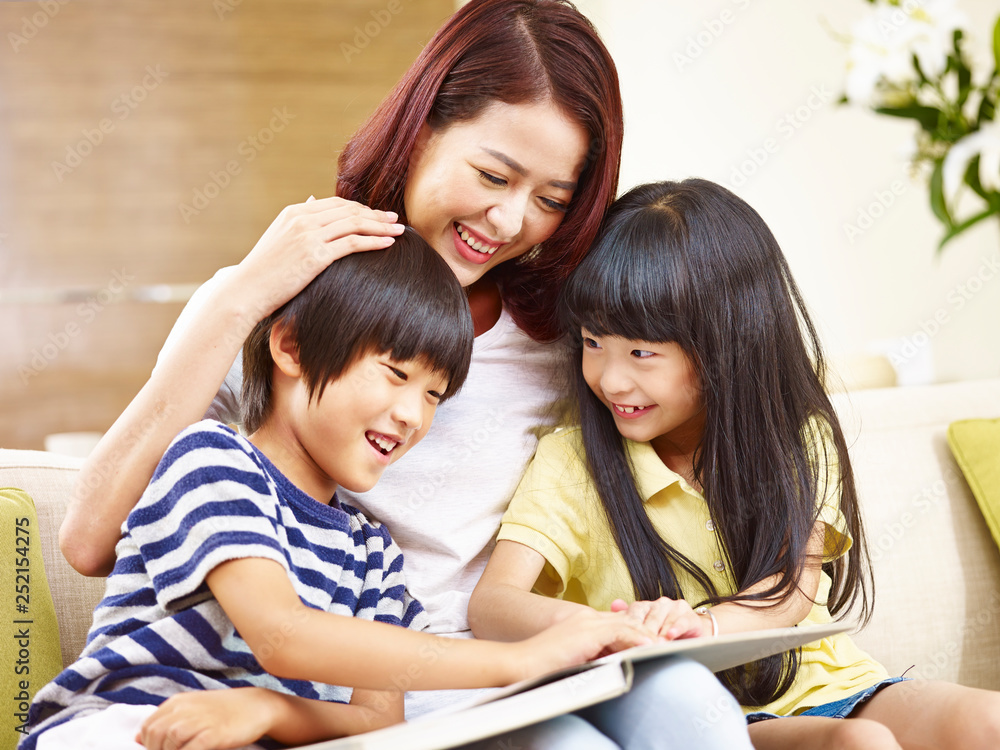 asian mother reading story to two children asian mother reading story to two children