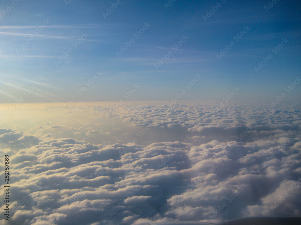 Aerial view of the blue sky and clouds from the airplane window
