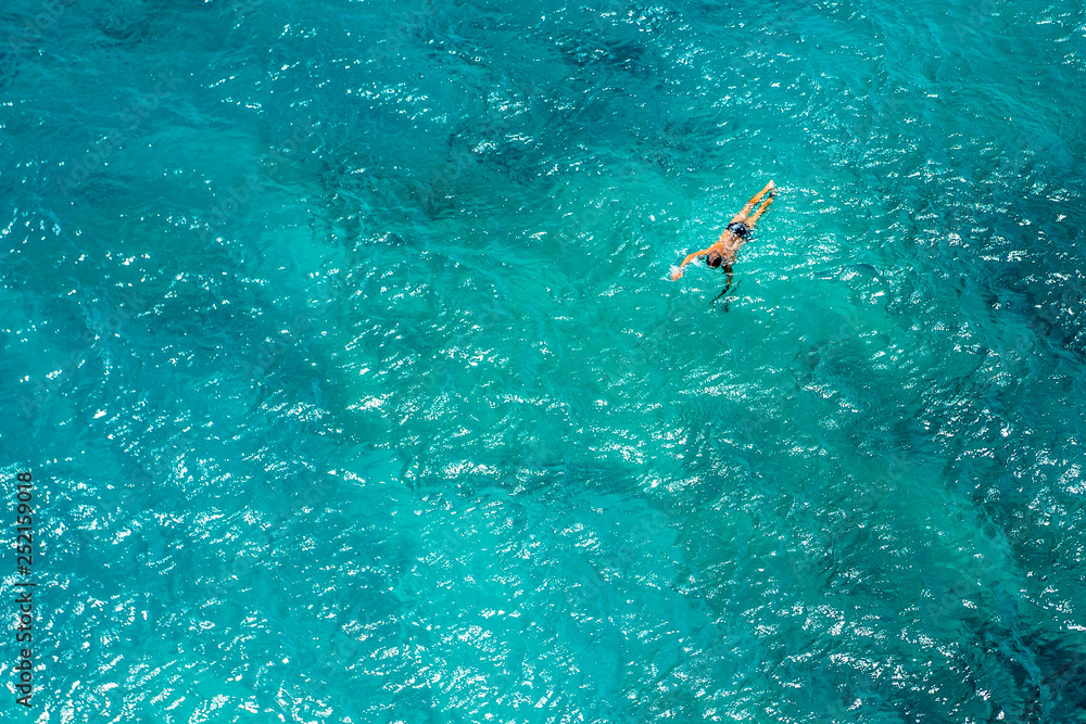 Aerial photo of a long distance swimmer in turquoise waters of Mediterranean Sea.