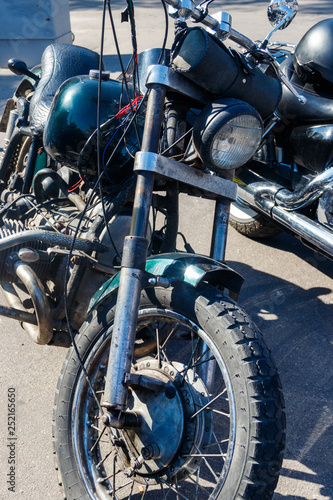Close-up of motorcycle parked on city street © olyasolodenko