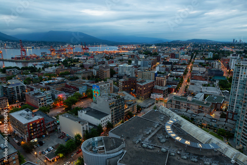 Downtown Vancouver, British Columbia, Canada - June 22, 2018: Aerial view of the modern city during night time after a cloudy sunset.